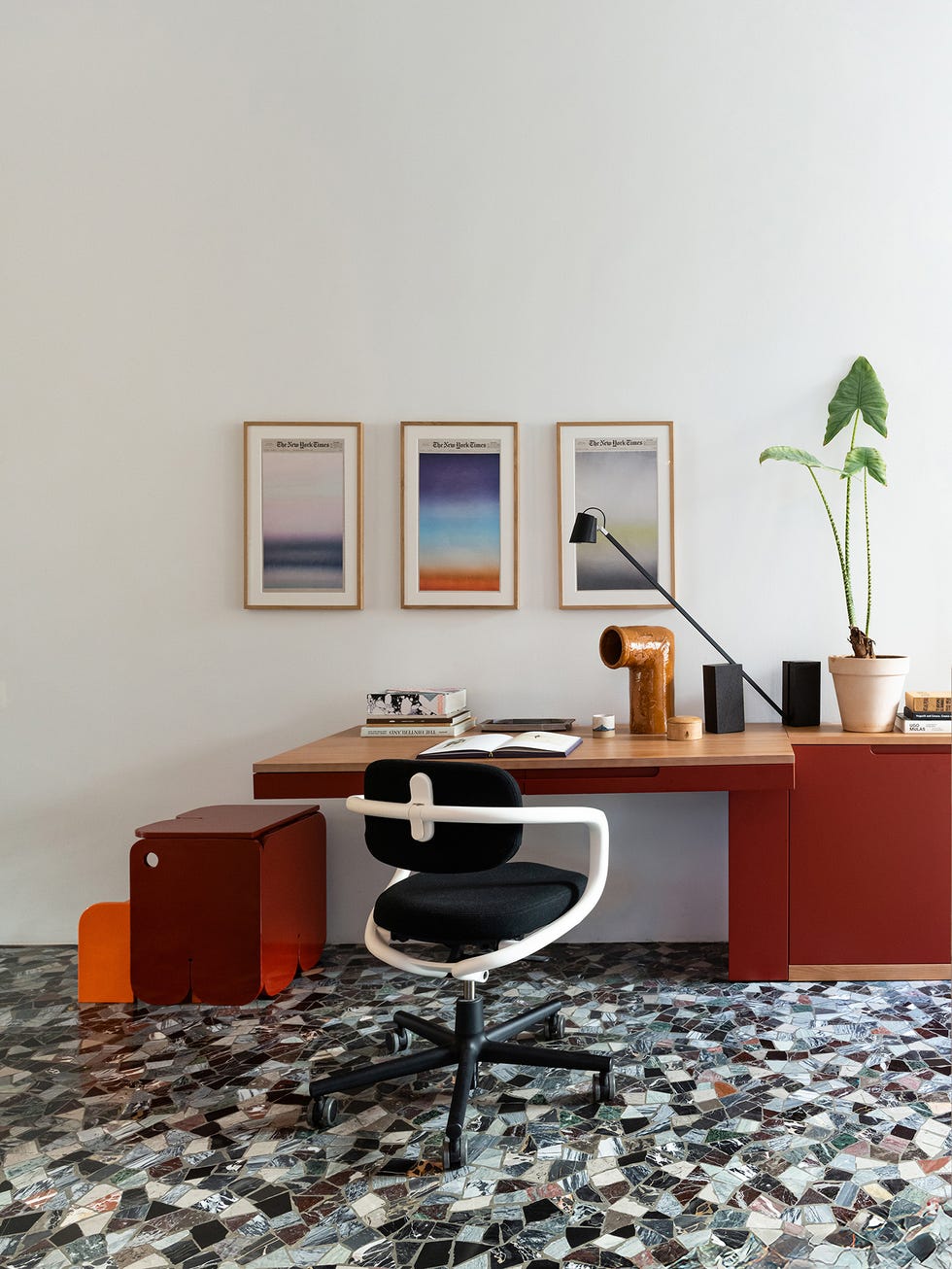 Modern workspace featuring a desk, chair, and decorative elements.