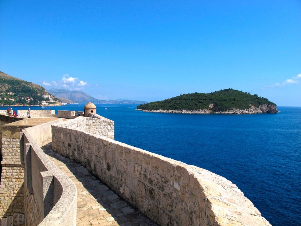 De muren van Dubrovnik met het eiland Lokrum in de verte
