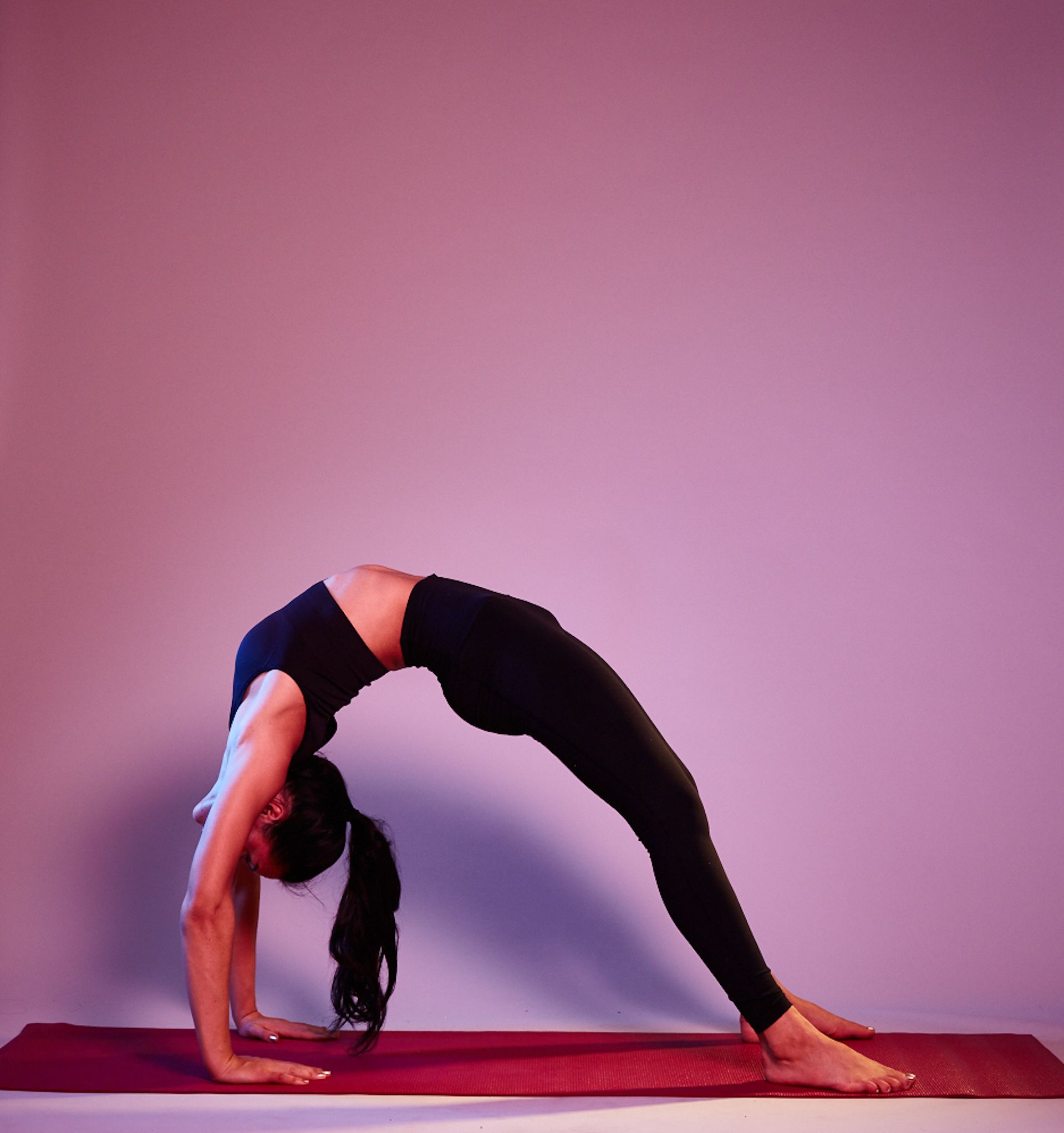 Young Woman Bending Backward In Yoga Pose Touching Feet Side View High-Res  Stock Photo - Getty Images