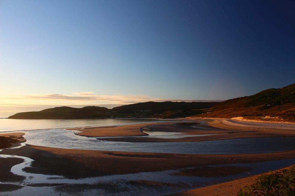a body of water with land in the back