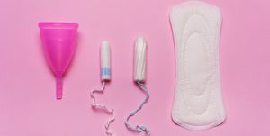 Pad, menstrual cup, tampon on a pink background.