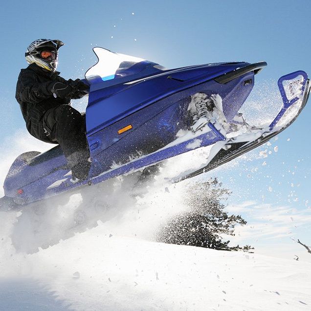 man lands snowmobile stunt