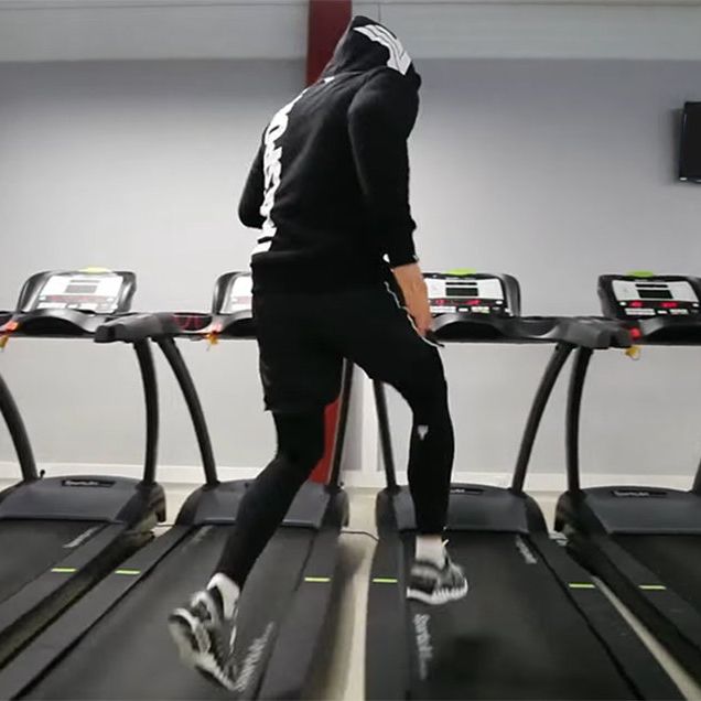 man runs across treadmills