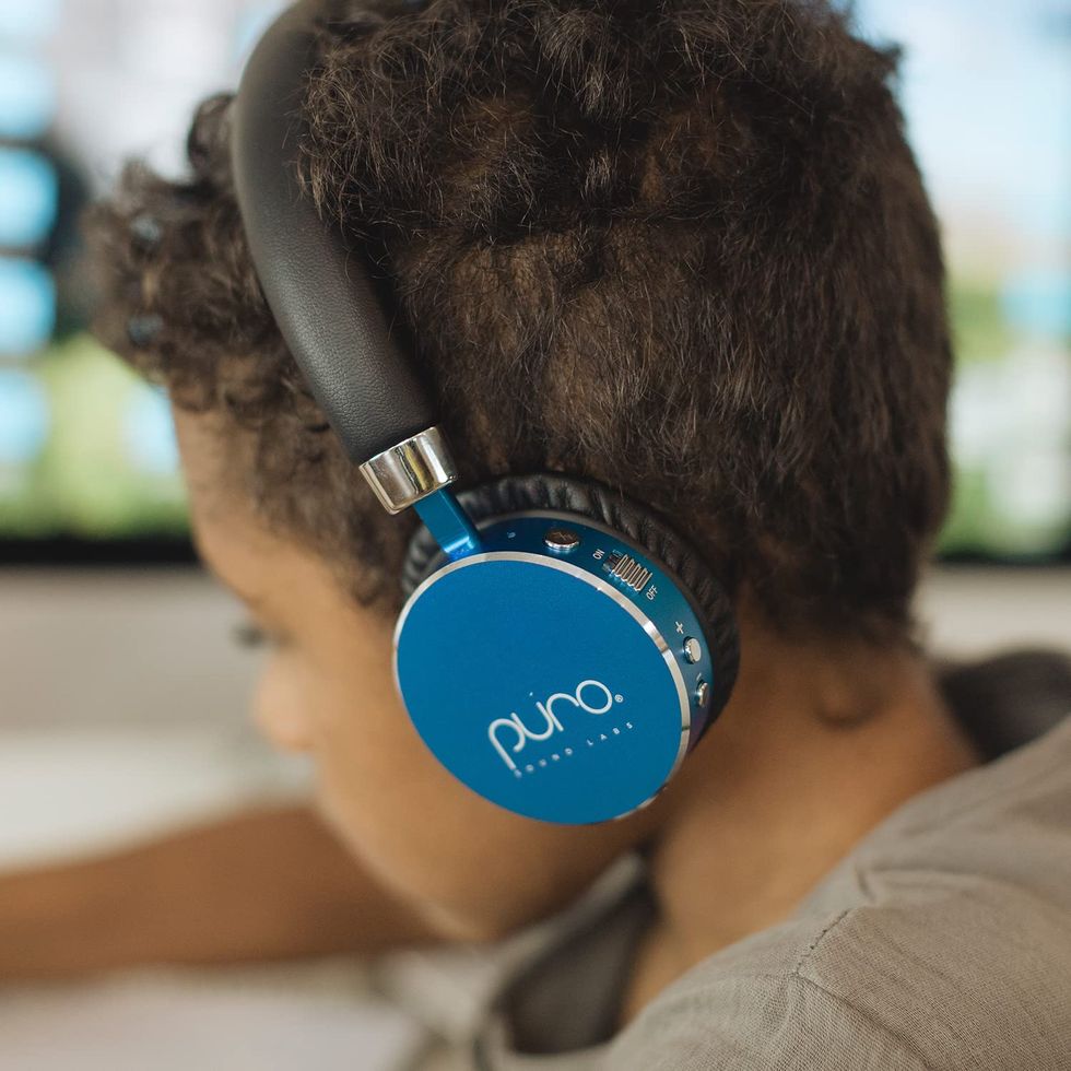 puro sound labs bt2200s volume limited kids’ bluetooth headphones in blue, being worn by a boy