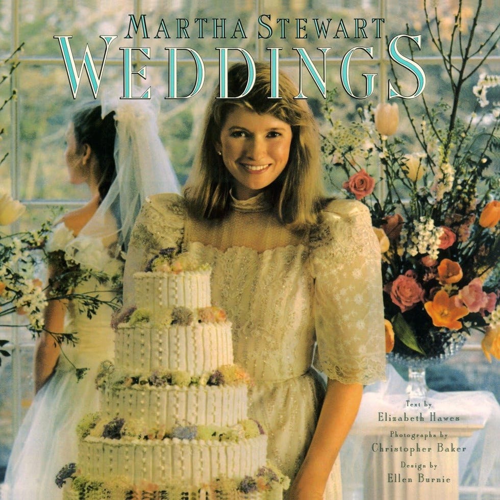 wedding scene featuring a bride a wedding cake and floral decorations