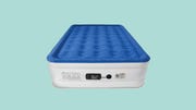 a blue and white air mattress on a turquoise background