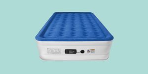 a blue and white air mattress on a turquoise background