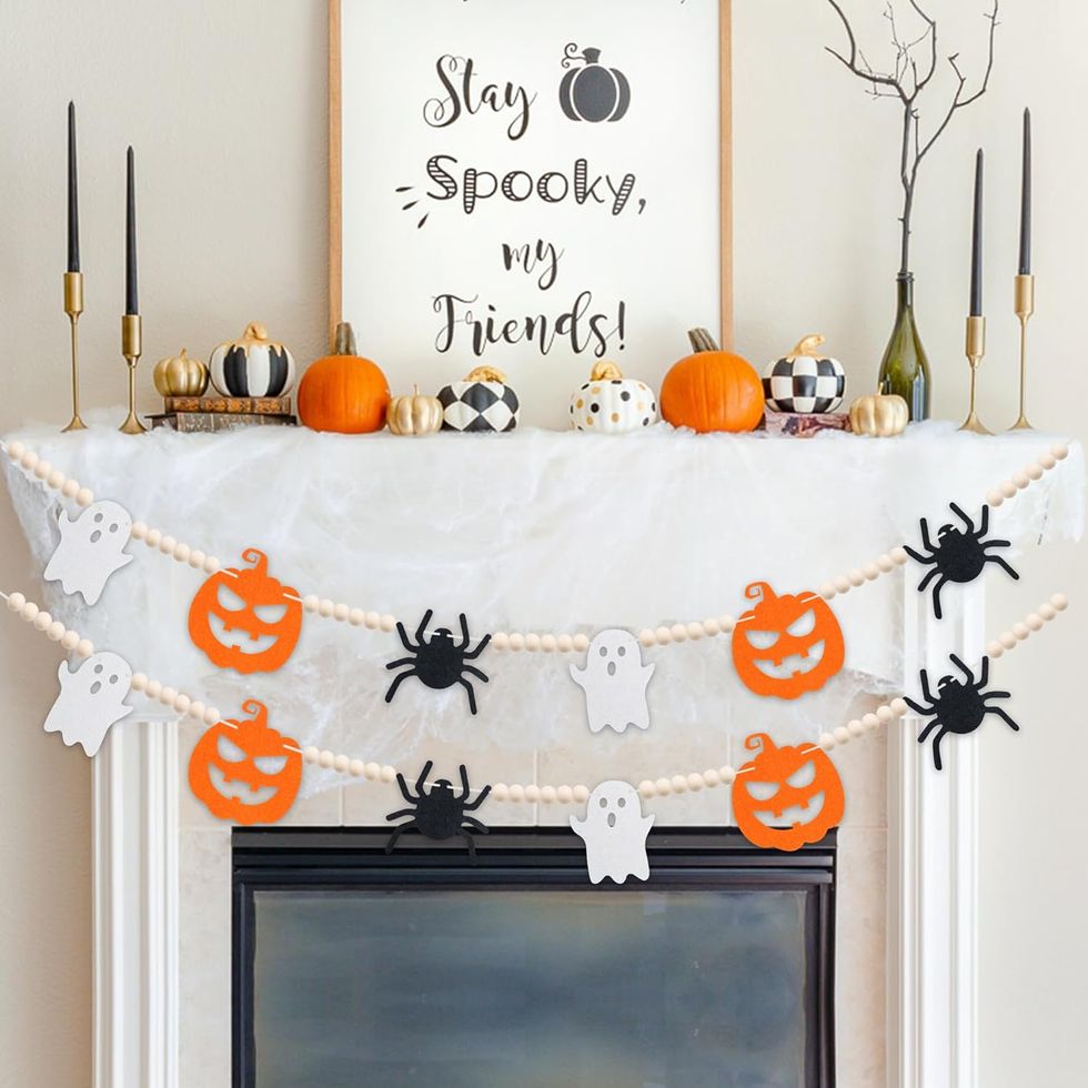 a white shelf with pumpkins and a sign on it