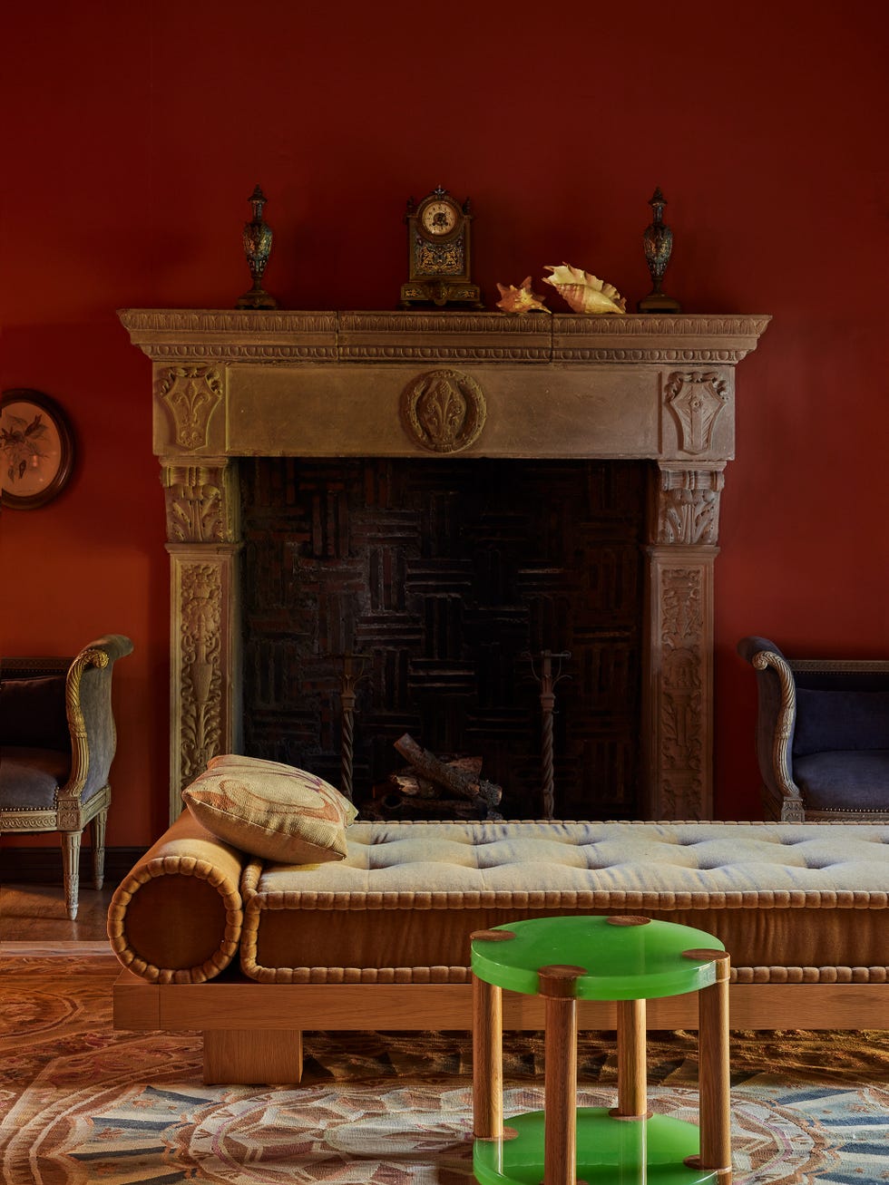 Cozy interior scene featuring a sofa, fireplace, and decorative items.