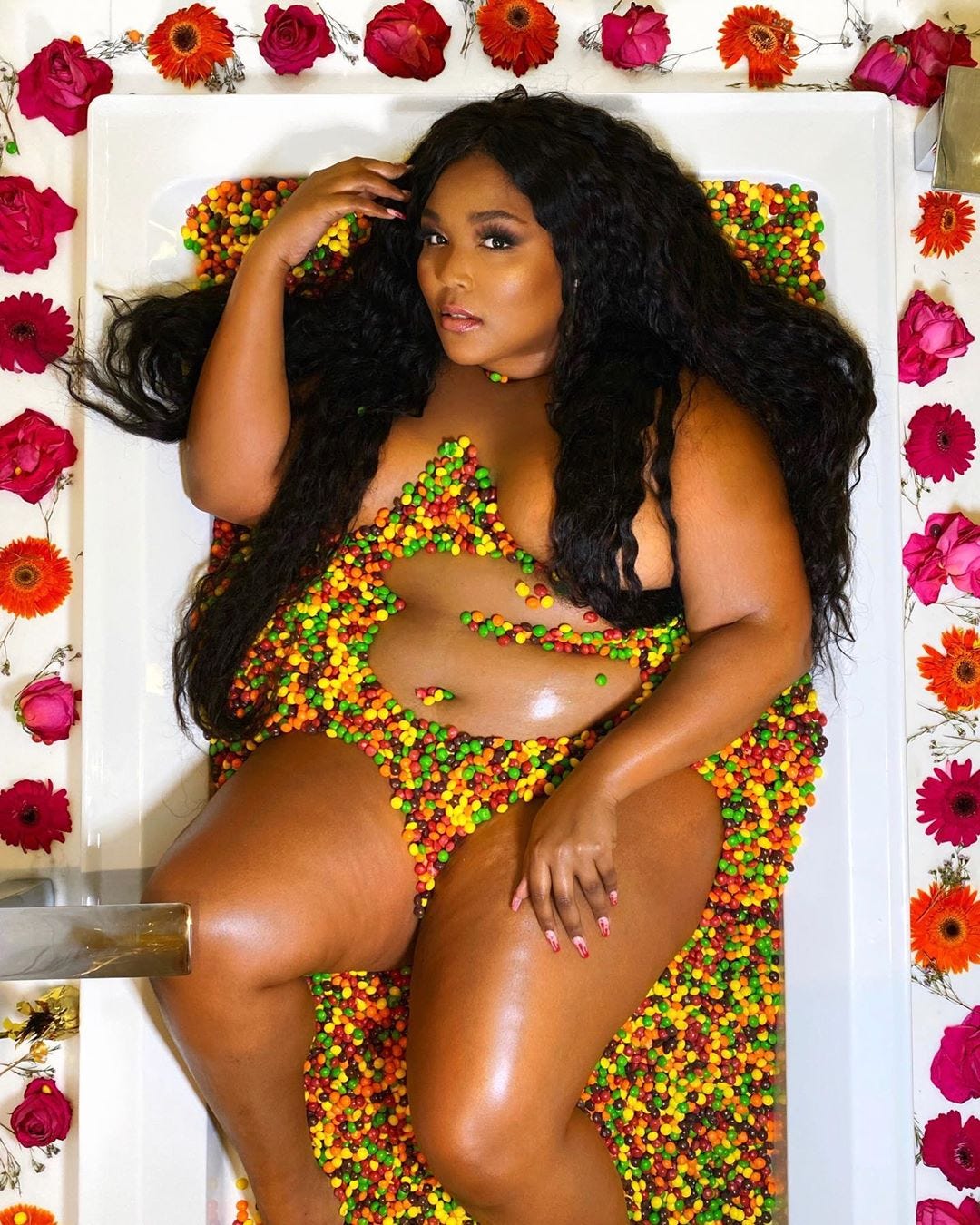 Lizzo Poses Nude Lying In Skittle-Filled Bathtub In NSFW Instagram