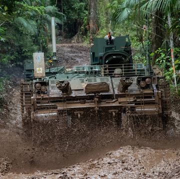 armored vehicle rolling through mud
