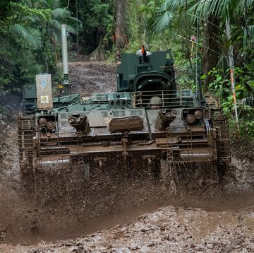 armored vehicle rolling through mud