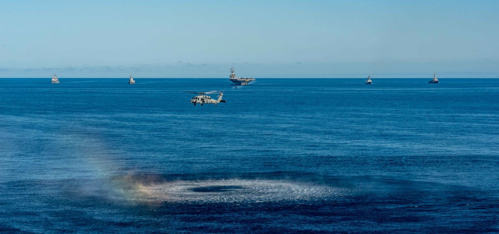 220930 n dw158 1319 waters east of the korean peninsula sept 30, 2022 an mh 60s sea hawk attached to the golden falcons of helicopter sea combat squadron hsc 12, hovers in front of the us navy’s only forward deployed aircraft carrier, uss ronald reagan cvn 76, a us navy los angeles class fast attack submarine, ticonderoga class guided missile cruiser uss chancellorsville cg 62, arleigh burke class guided missile destroyer uss benfold ddg 65, republic of korea rok navy destroyer roks munmu the great ddh 976 and japan maritime self defense force jmsdf destroyer js asahi dd 119, as they steam in formation in waters east of the korean peninsula, sept 30 ronald reagan, operating as the flagship of carrier strike group csg 5 is conducting a trilateral anti submarine warfare exercise with the jmsdf and rok navy the operations between the reagan strike group, js asahi, and roks munmu the great, involved operating with a us submarine to enhance interoperability between the nations in support of a free and open indo pacific us navy photo by mass communication specialist 3rd class gray gibson