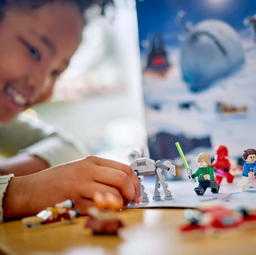LEGO star wars advent calendar 2024 young girl plays with lego star wars advent calendar 2024