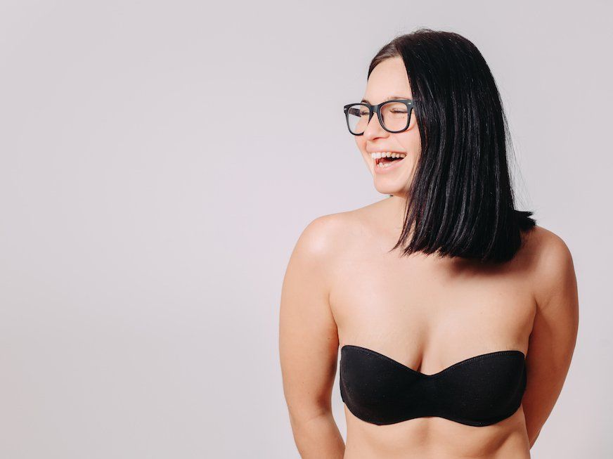 Beautiful mixed race Asian girl with big breasts, wearing a bra