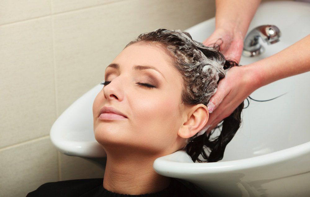 woman having hair washed at salon