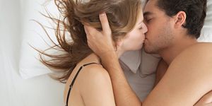 couple in bed kissing