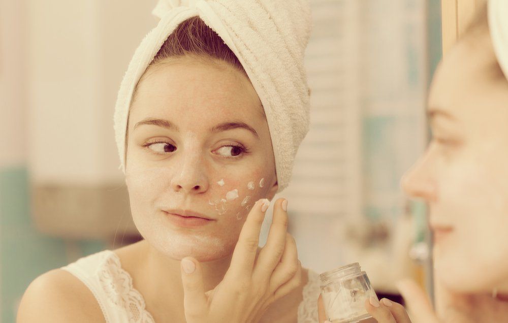 woman applying anti-aging moisturizer