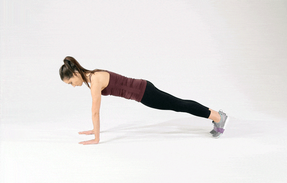 Woman doing mountain climbers with resistance band