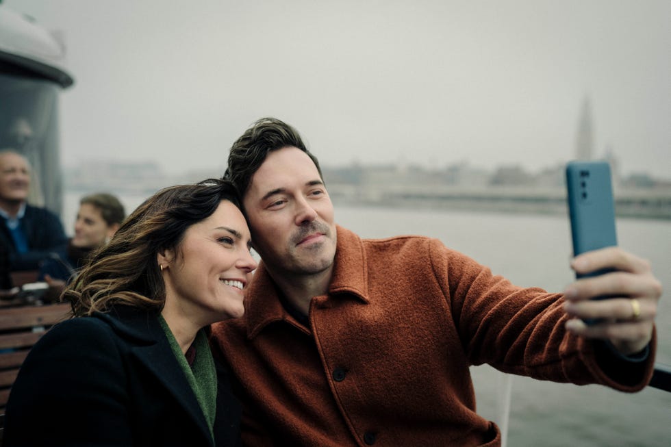 jacob (sam palladio) and charlotte (annabel scholey) take a selfie on a boat trip in antwerp.