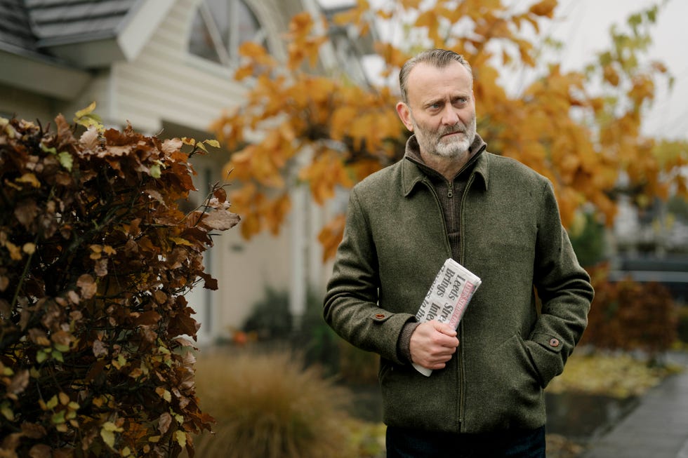 alan (hugh dennis) walks home through the cul de sac, with a copy of the local paper