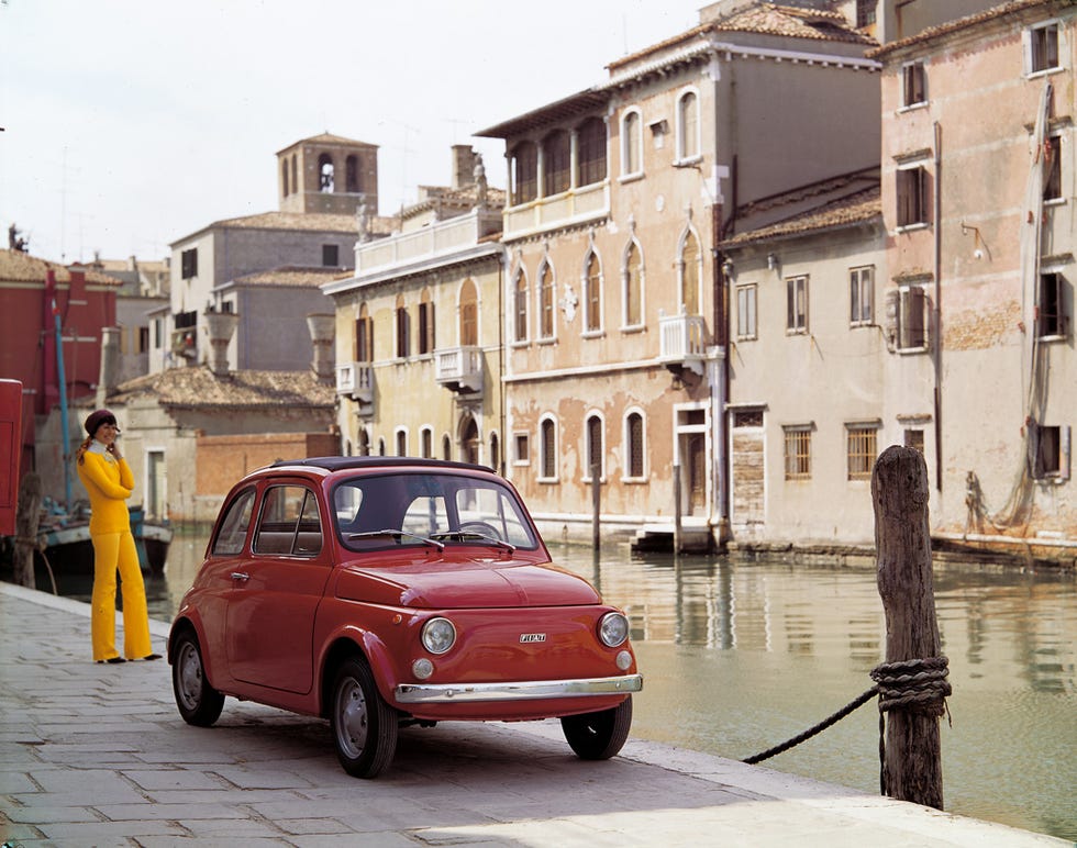 classsic fiat 500 near water in italy