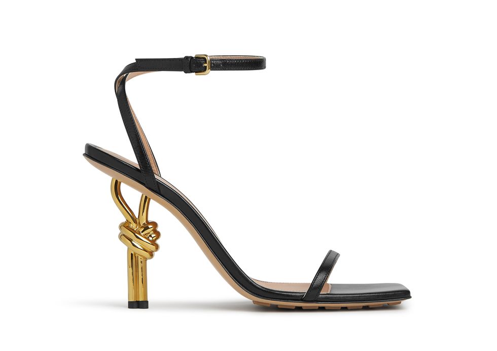 a gold and black high heeled shoe