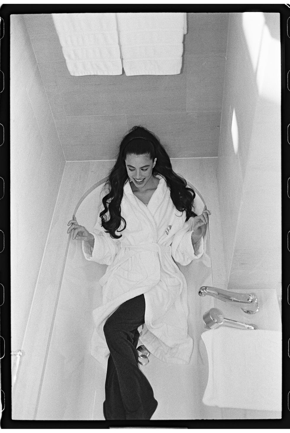 a person relaxing in a bath robe in a modern bathroom setting