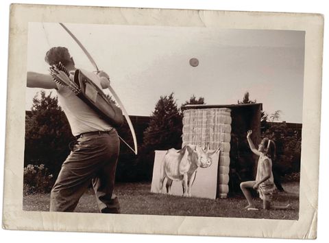 bob swinehart with his daughter practicing archery