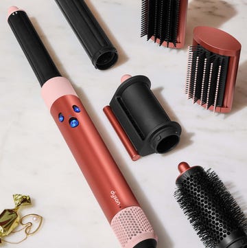 beauty styling tools including a hair styling device and various attachments on a marble surface beauty styling tools including a hair styling device and various attachments on a marble surface