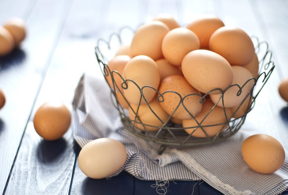 fresh farm eggs in a wire basket