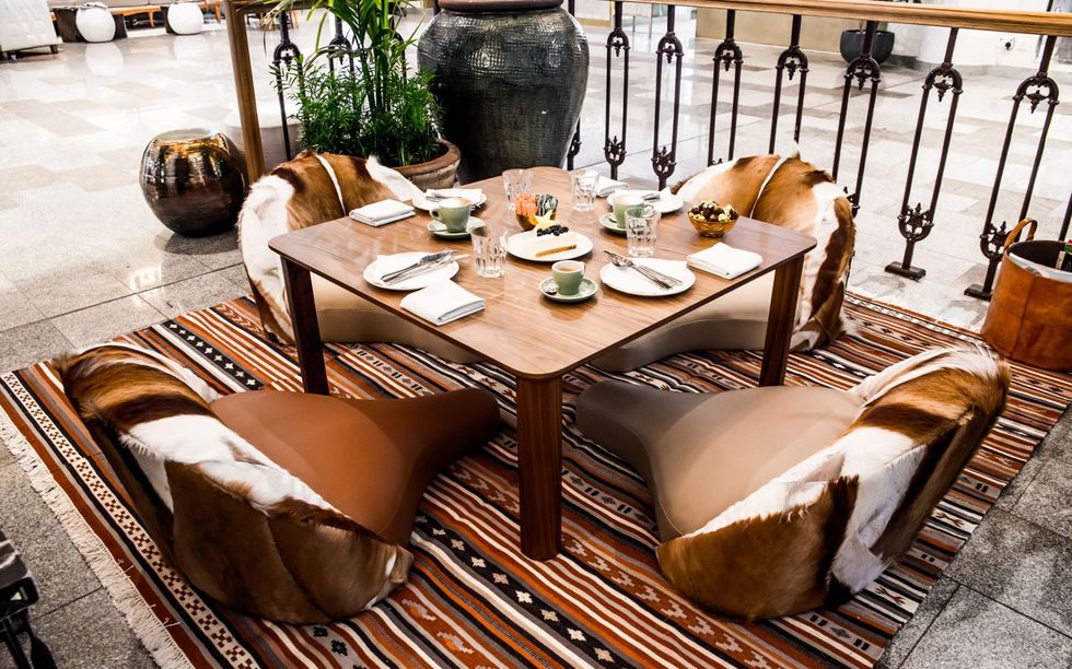 Table, Dining room, Furniture, Room, Coffee table, Tablecloth, Brown, Interior design, Textile, Kitchen & dining room table, 
