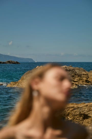 a person's head looking out over the water