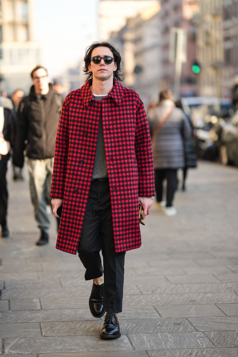 milan, italy january 13 a guest wears sunglasses, a black and red checked coat, a gray pullover, suit pants, leather loafers shoes, outside msgm, during the milan fashion week menswear fallwinter 2024 2025 on january 13, 2024 in milan, italy photo by edward berthelotgetty images