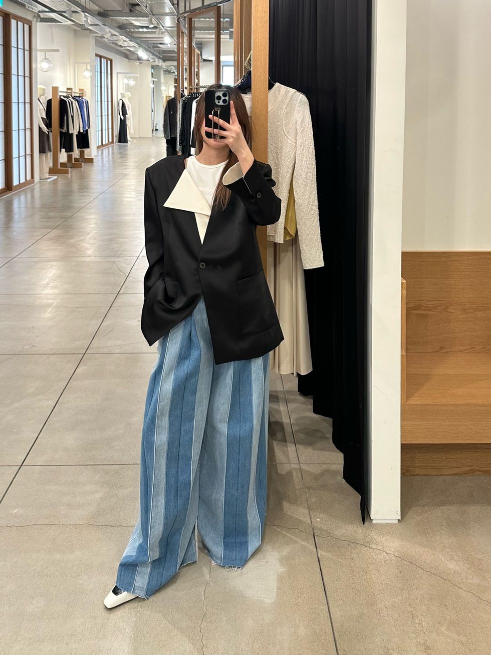 a person taking a selfie in a clothing store