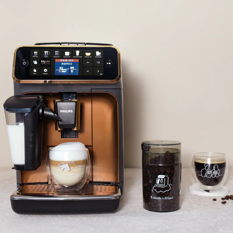a coffee maker with a glass jar and a glass jar of milk