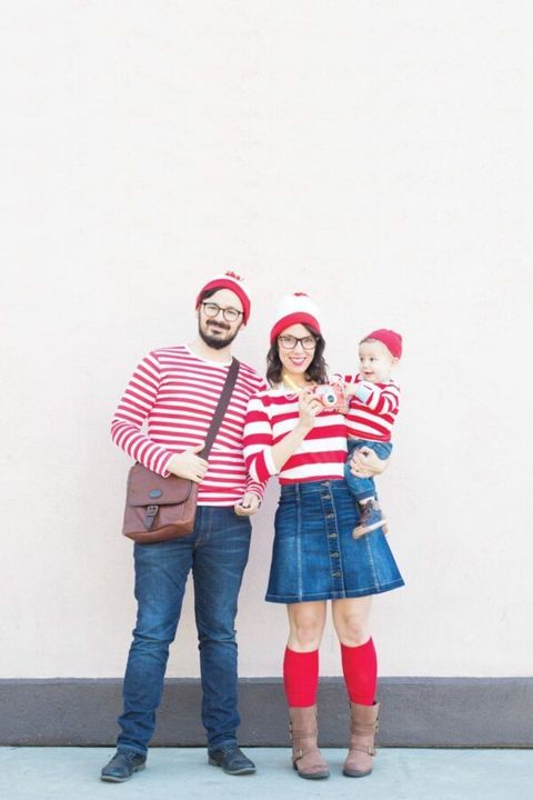 a family of three each dressed as waldo from the 'where's waldo' books as part of a group '80s halloween costume