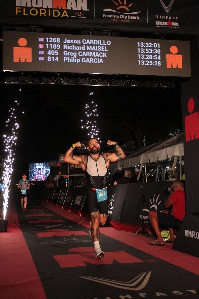 participants crossing the finish line of an ironman triathlon event