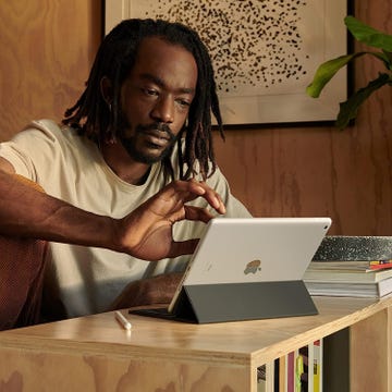 a person sitting at a desk with a laptop