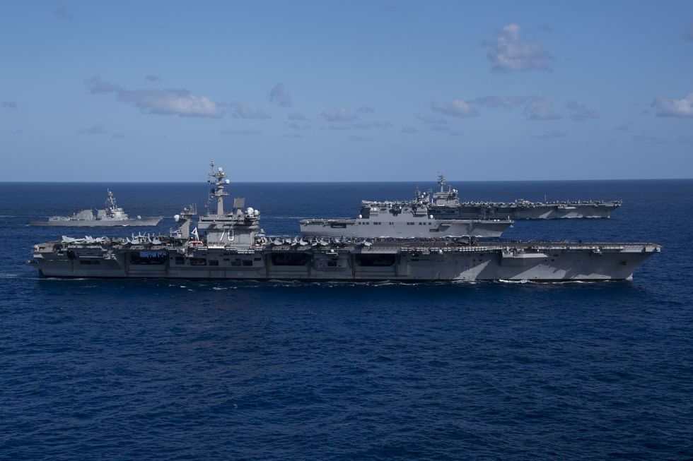 240131 n rd316 1211 philippine sea jan 31, 2024 from left to right, arleigh burke class guided missile destroyer uss daniel k inouye ddg 118, nimitz class aircraft carrier uss carl vinson cvn 70, hyuga class helicopter destroyer js ise ddh 182, and nimitz class aircraft carrier uss theodore roosevelt cvn 71 sail in formation during multi large deck event mlde, jan 31 the event comprising carl vinson carrier strike group, theodore roosevelt carrier strike group and the japan maritime self defense force is designed to advance combined readiness between japan and us maritime forces while simultaneously demonstrating our commitment to our partners and allies in the indo pacific vinson, flagship of carrier strike group one, is deployed to the us 7th fleet area of operation in support of a free and open indo pacific us navy photo by mass communication specialist 3rd class marissa johnson