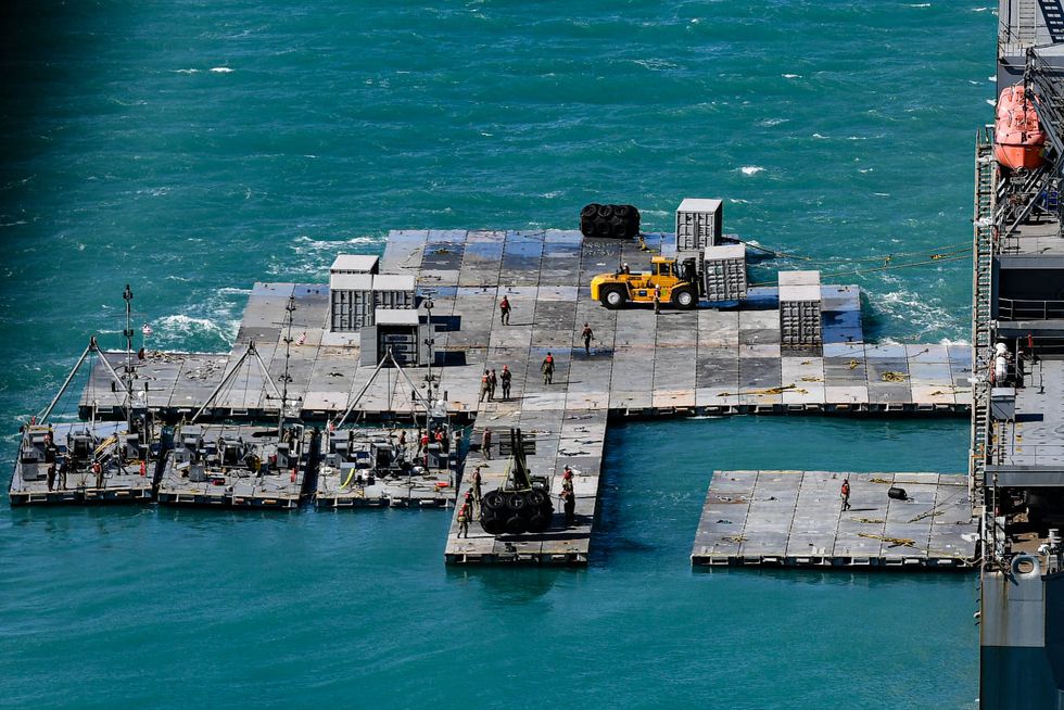 army mariners work to construct a causeway adjacent to the mv maj bernard f fisher off the coast of bowen, australia, july 28, 2023 when complete, the causeway will form a floating pier enabling the discharge of vehicles from the fisher to shore demonstrating the critical capability of joint logistics over the shore jlots during talisman sabre jlots demonstrates the critical capability of bringing vehicles and equipment to the shore in austere environments or when port facilities are unavailable talisman sabre is the largest bilateral military exercise between australia and the united states, with multinational participation, advancing a free and open indo pacific by strengthening relationships and interoperability among key allies us army photo by sgt david resnick