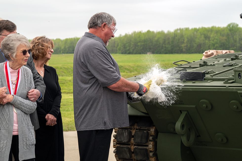 family members of us army pvt robert d booker break a bottle of champagne on the front of the m10 booker combat vehicle during the official christening and m10 booker dedication ceremony at aberdeen proving ground, in aberdeen, md, april 18, 2024 also participating in the christening ceremony were brig gen wilson and command sgt maj reffeor, both with the 3rd infantry division, joined by command sgt maj luck and sgt maj queck, both with the 34th infantry division us army photo by christopher kaufmann
