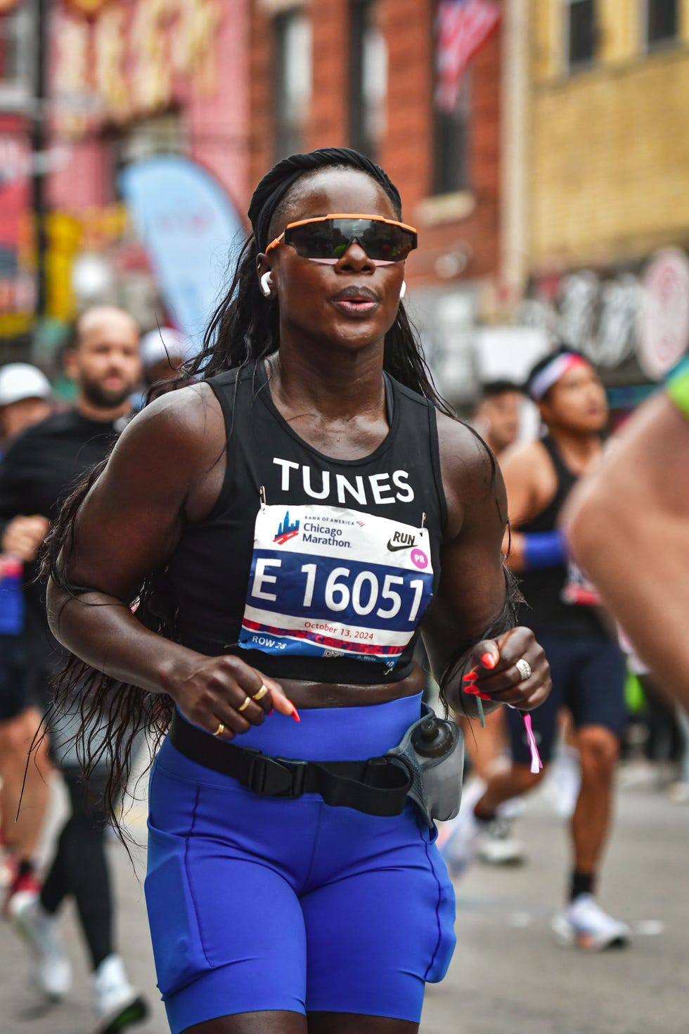 a woman wearing running clothing competing in a race