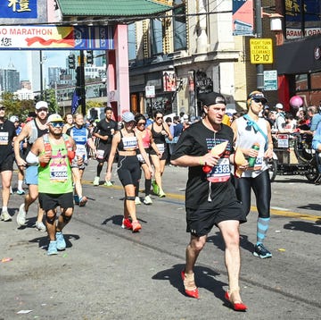 a man running a marathon wearing red high heels for domestic violence awareness a man running a marathon wearing red high heels for domestic violence awareness