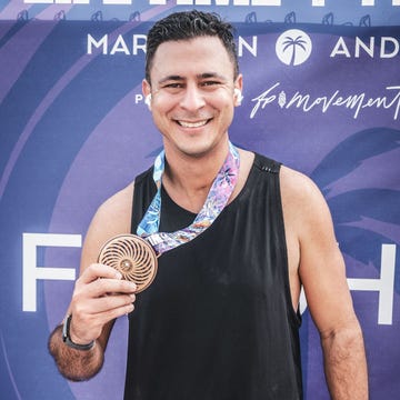 participant holding a medal at a marathon event farouk gomati guillain barre syndrome participant holding a medal at a marathon event farouk gomati guillain barre syndrome