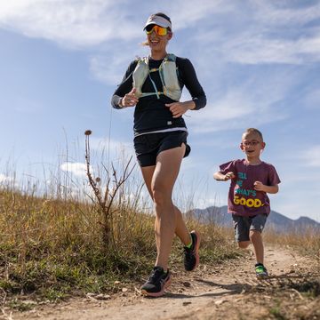 a woman and a young boy Running lifestyle on a sandy trail