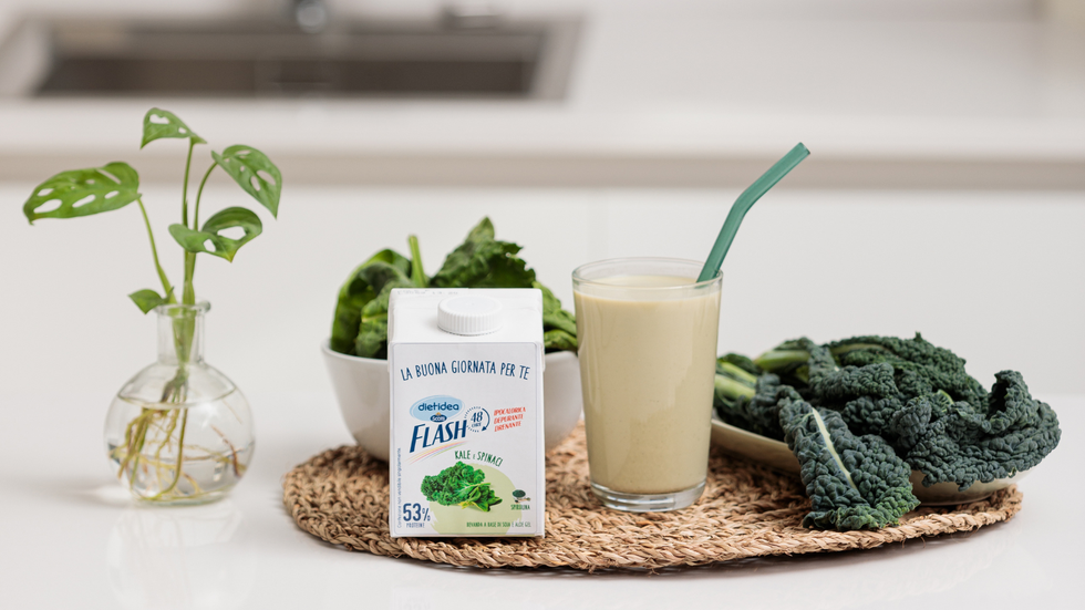 a table with a glass of milk and a jar of herbs