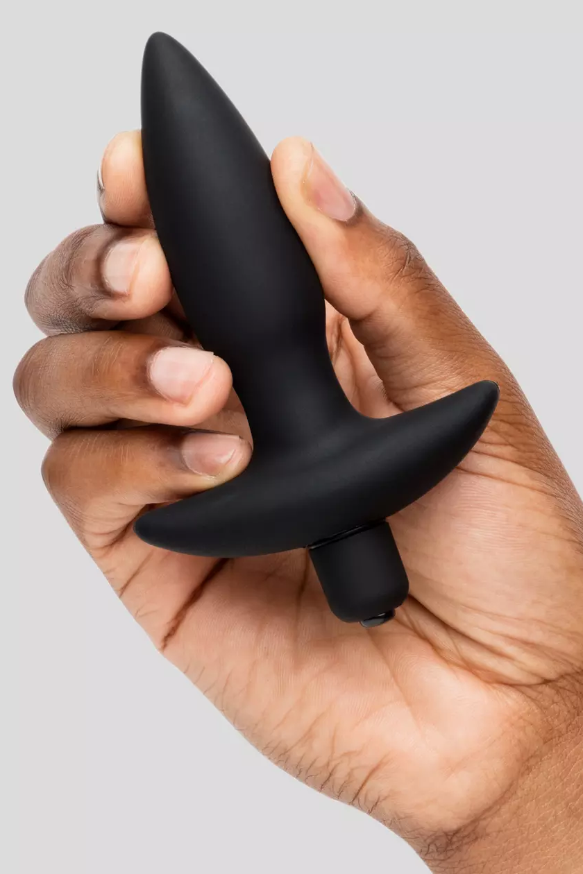 a hand holding a black object