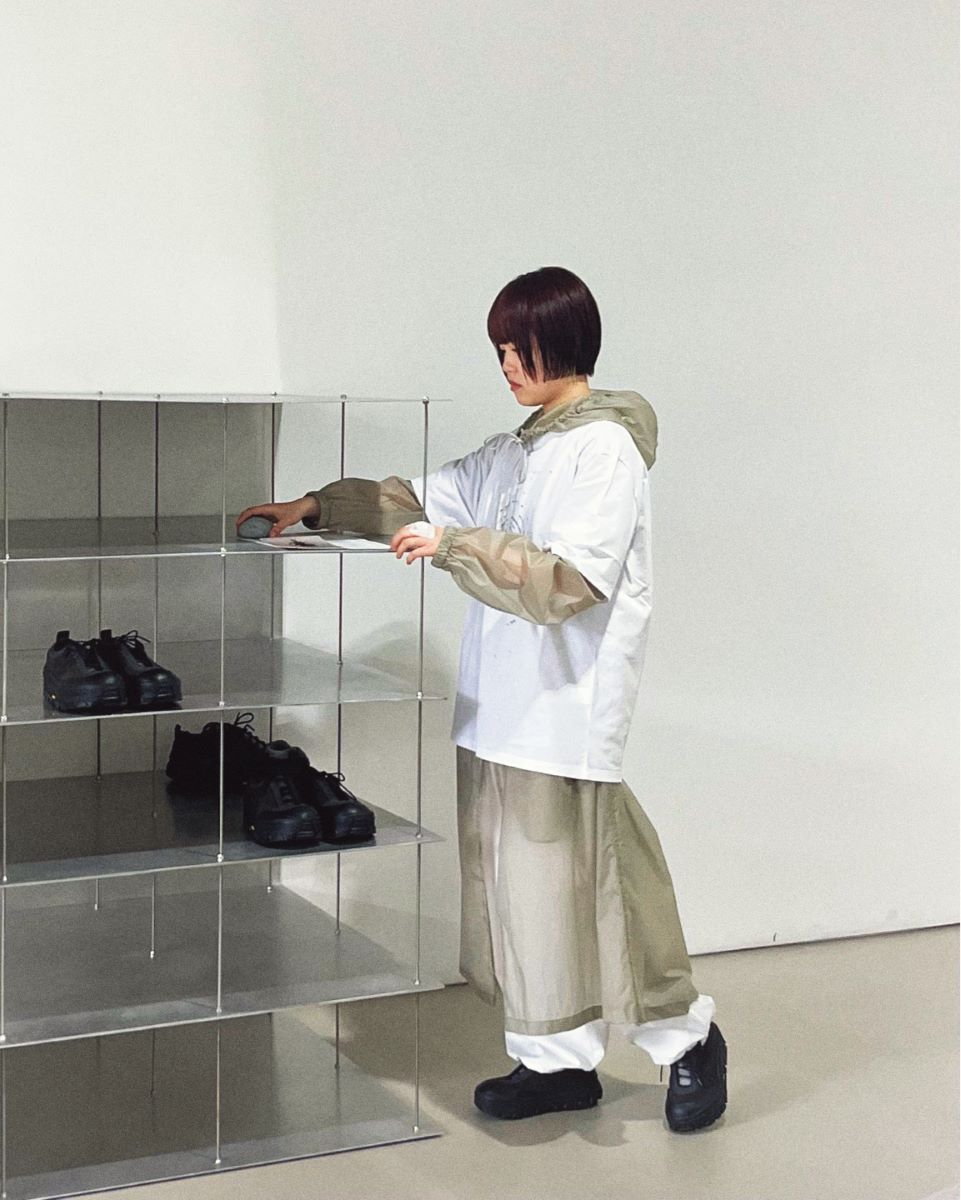 a boy standing on a glass shelf