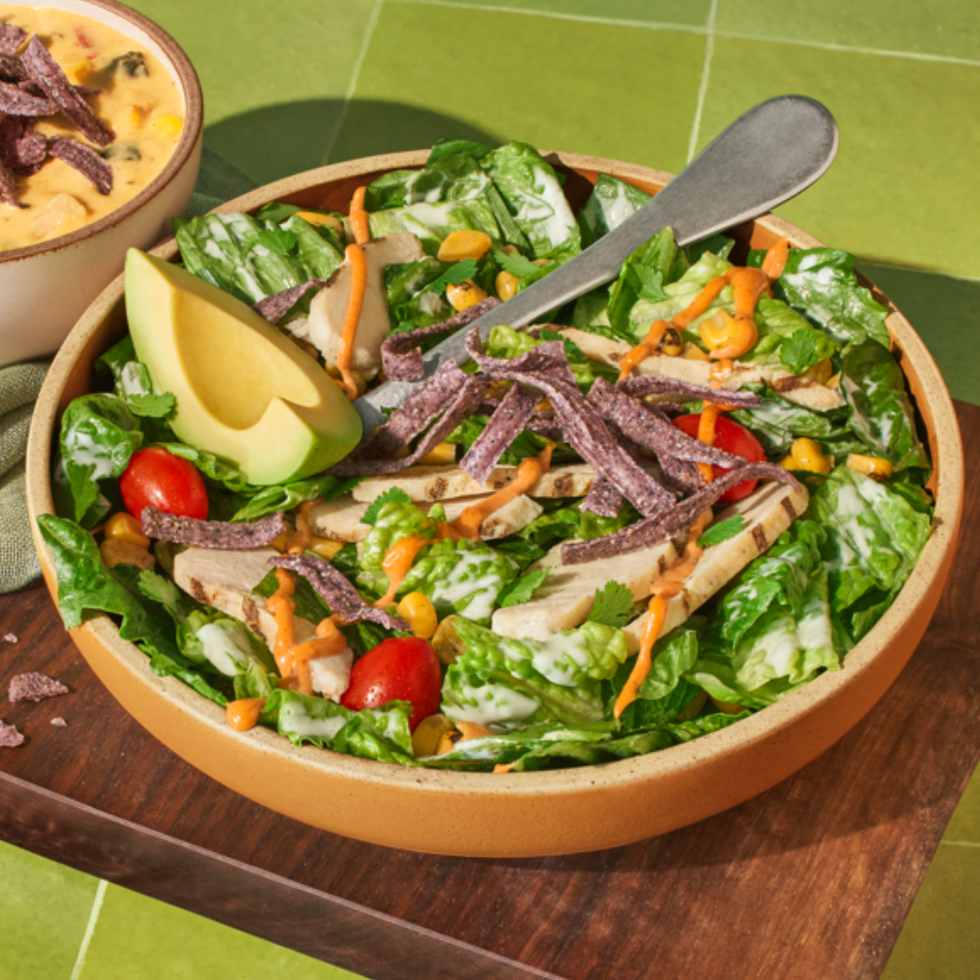a bowl of salad with a knife
